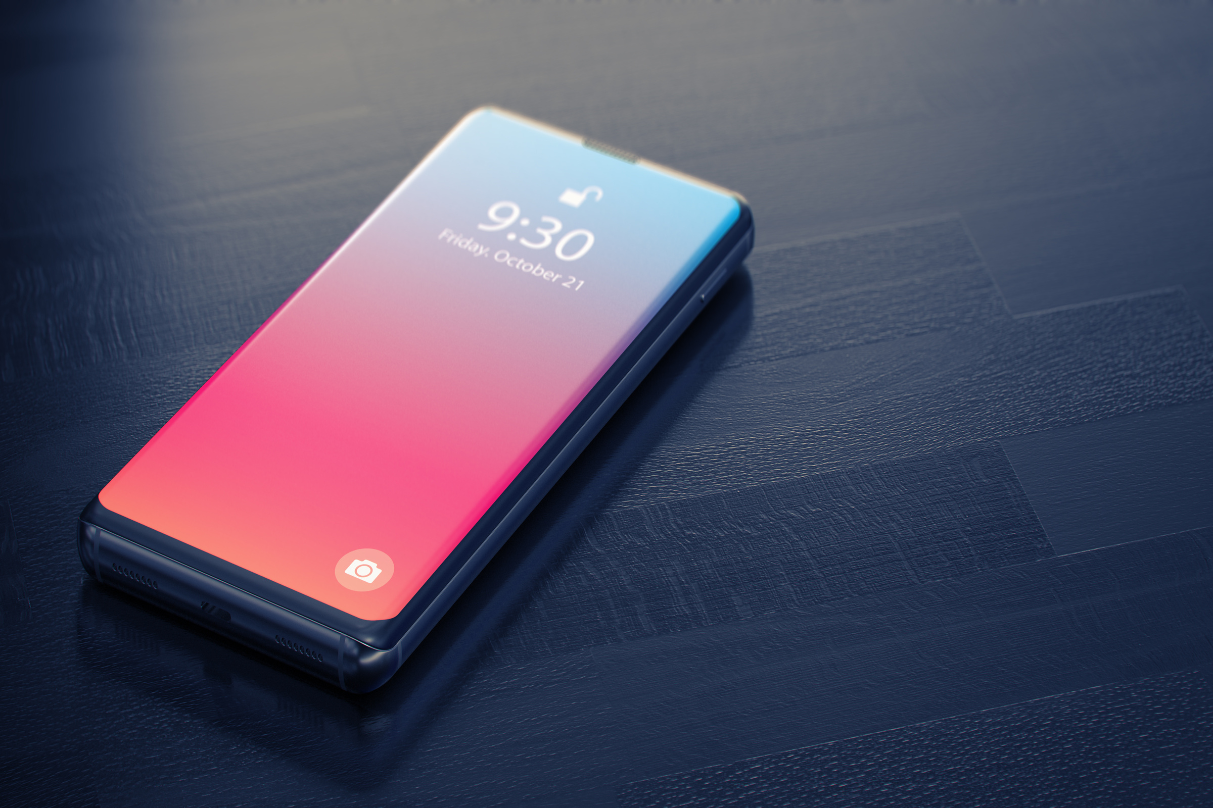 Włączony smartfon leżący na czarnym biurku.