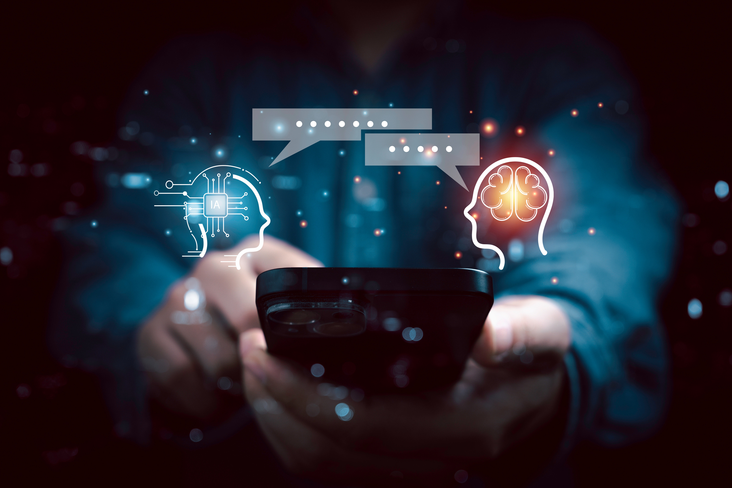 Smartfon trzymany w dłoni z ikonkami symbolizującymi osobę rozmawiającą z chatbotem Ai.