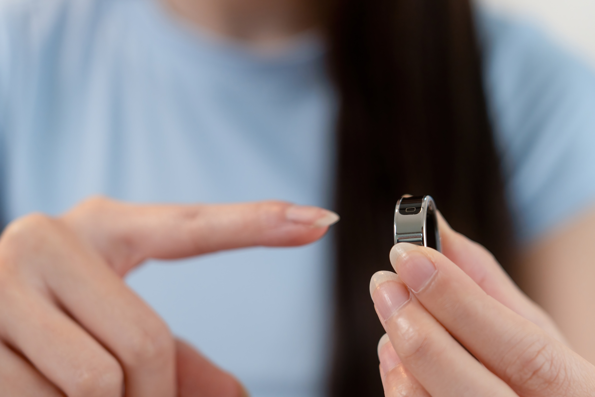 Kobieta zakłada na palec smart ring